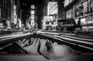 Homeless man sleeping in the middle of Times Square