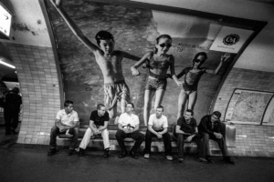 Men sitting at a metro station in Paris